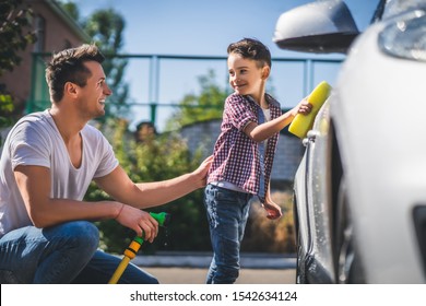 The daddy and his son cleaning the car - Powered by Shutterstock