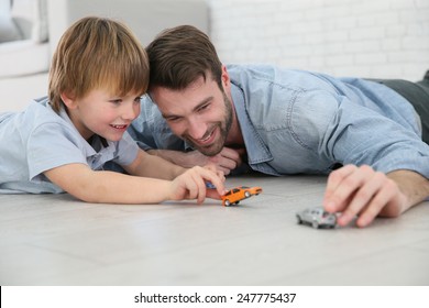 Daddy With Little Boy Playing With Toy Cars