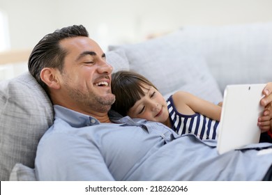 Daddy With Little Girl Playing With Tablet