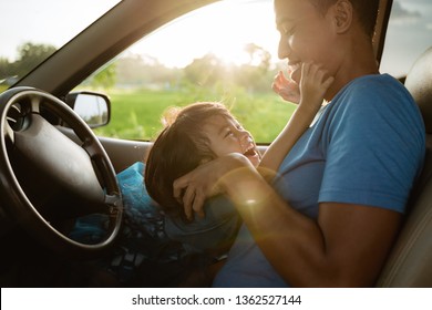 daddy tickling her little girl in the car sitting on his lap. laugh happy with father having fun