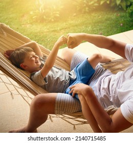 Daddys always got your back my boy. Cropped shot of a father and his adorable son chilling on the hammock outside. - Powered by Shutterstock