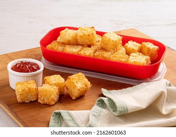 Dadinho de Tapioca - Traditional  fingerfood from Brazil  - Squares of tapioca and cheese served with pepper jelly. Wooden table. Space for text - Dice of tapioca - Dadinho de tapioca