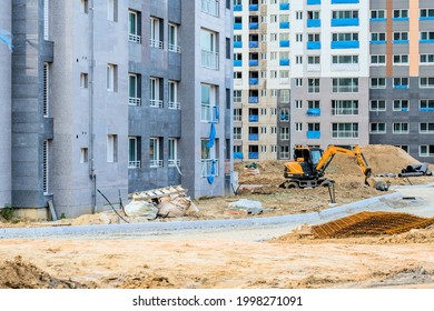 Daejeon; South Korea; June 20, 2021: Small Hyundai backhoe sitting idle at construction site in Sintanjin Dong.