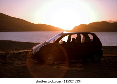 Daewoo Matiz car in sunset light on the coast line