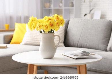 Daffodil flowers in jug on coffee table in living room - Powered by Shutterstock