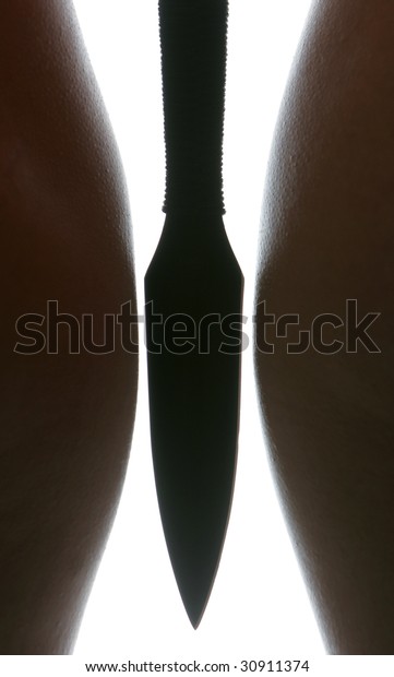 A dagger between nude\
female hips