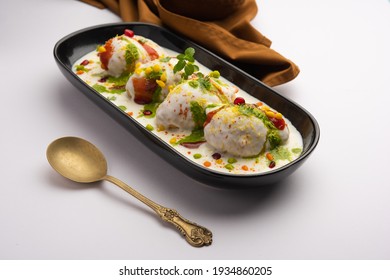 Dahi vada or bhalla is a type of chaat originating from the Indian and popular throughout South Asia. It is prepared by soaking vadas in thick dahi or curd. selective focus