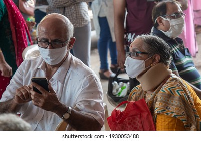 DAHISAR, MUMBAI, INDIA - March 1, 2021: Old Age Couple Enters The Dahisar Jumbo Covid Vaccination Center To Get Covid-19 Coronavirus Vaccine At Dahisar Jumbo Covid Center. DAHISAR, MUMBAI, INDIA