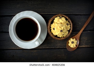 Dahlia Flower Shaped Butter Cookies Or Biskut Semperit In Malay Served With A Cup Coffee.Popular Cookies In Malaysia During Hari Raya. Served On Black Wooden Table