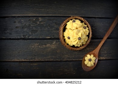 Dahlia Flower Shaped Butter Cookies Or Biskut Semperit In Malay Served With A Cup Coffee.Popular Cookies In Malaysia During Hari Raya. Served On Black Wooden Table