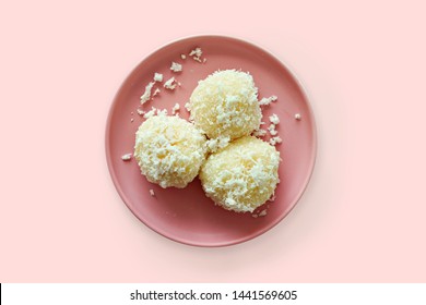 Daifuku mochi (glutinous rice cakes) filled with fresh mango, coated with shredded coconut. Top View.