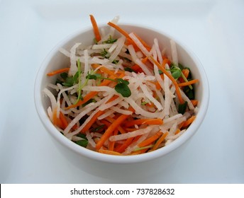 Daikon And Carrot Slaw In A White Bowl.