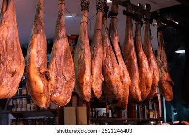 Daily farmers market in Triana, Sevilla, different ham jamon serrano legs, cheese and sausages to sell by local people - Powered by Shutterstock