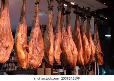 Daily farmers market in Triana, Sevilla, different ham jamon serrano legs, cheese and sausages to sell by local people - Powered by Shutterstock