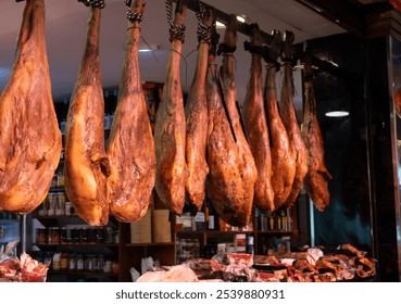 Daily farmers market in Triana, Sevilla, different ham jamon serrano legs, cheese and sausages to sell by local people - Powered by Shutterstock