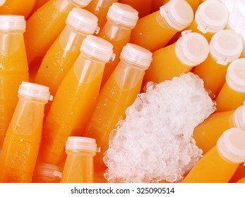 daily fresh homemade carrot pressed juice in plastic bottle in ice box for sale on a street market in THAILAND 