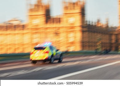 Daily Life In The City. Police Car In Action On The Westminster Bridge In London - Blurred Motion