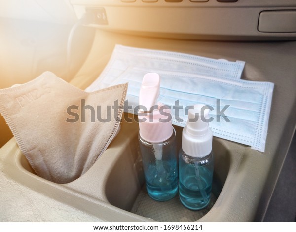 Daily necessities new normal,\
Coronavirus covid-19 pm2.5, masks and hand sanitizer gel and spray\
In the storage in front of the car for hand hygiene spread\
protection
