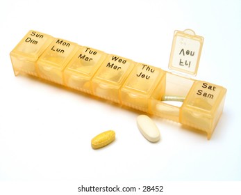 A Daily Pill Container Filled With Various Types Of Pills.