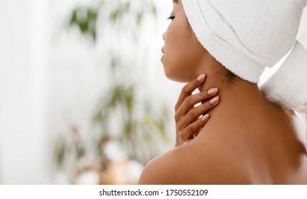 Daily Spa. Nude African Woman With Towel On Head Touching Her Soft Skin On Neck, Enjoying Her Young Beauty, Closeup Image With Copy Space