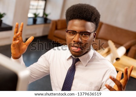 Daily work issues. Face of a nice emotional office worker while dealing with his work