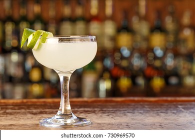 
Daiquiri cocktail with rum and lime juice  on the bar in a pub or restaurant. Traditional taste. Space for text.

