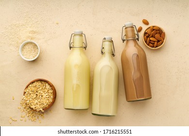 Dairy Alternative. Rice, Oat And Chocolate Almond Milk In Glass Bottles On Beige Background. Healthy Protein Vegan Drink. View From Above