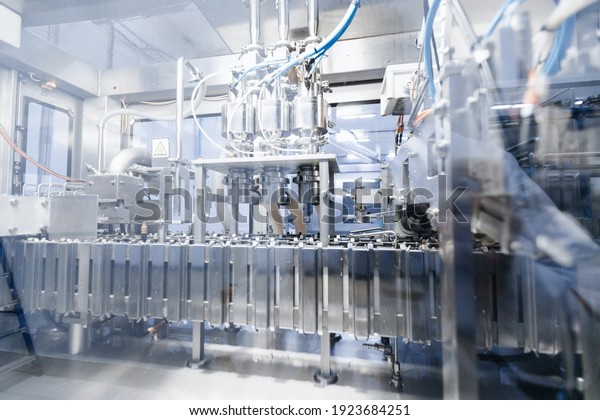 Dairy factory, plastic bags of packaged milk in\
automatic filling\
conveyor.