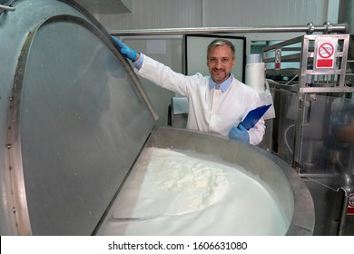 Dairy Plant Food Technologist Checking Milk Pasteurization Process. Milk Pasteurization In Dairy Processing Plant. Milk Inside The Pasteurization Tank. Dairy Plant Food Safety.