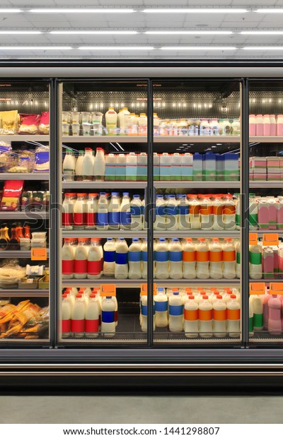 Dairy product in Glass door fridge Horizontal\
photo mockup yogurt and milk and plastic diary bottles in vertical\
freezer at supermarket. Suitable for presenting new Dairy packaging\
or label design