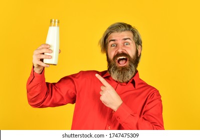 Dairy Products From Milk For Adults And Children. Happy Farmer Present Glass. Bearded Man Drink Useful Milk. Love Milk Mustache. Food And Drink Concept. Usefulness Of Milk. Pointing Finger.