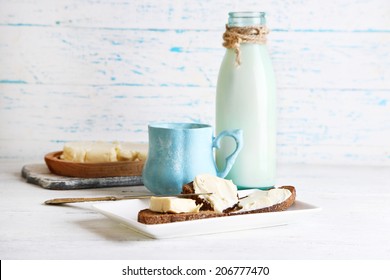 Dairy products: milk, butter, cottage cheese on wooden background