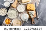 Dairy products.  Milk, cheese, sour cream, cottage, yogurt and butter on dark background