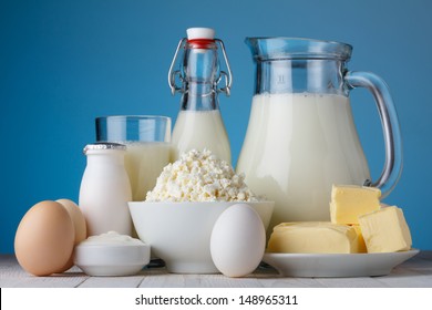 Dairy products, milk, cottage cheese, eggs, yogurt, sour cream and butter on wooden table