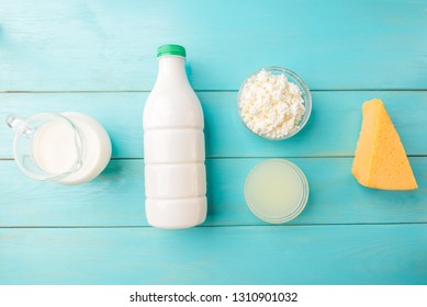 Dairy products. Milk, kefir, cottage cheese, cheese and whey on blue wooden background. - Shutterstock ID 1310901032