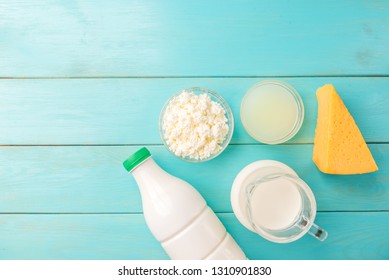 Dairy products. Milk, kefir, cottage cheese, cheese and whey on blue wooden background. - Shutterstock ID 1310901830