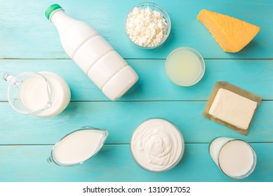 Dairy products. Milk, kefir, cottage cheese, cheese, whey, buttermilk, sour cream and cream on blue wooden background. Technology of making cheese and butter from milk. - Shutterstock ID 1310917052