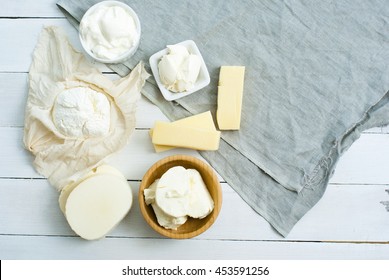 Dairy Products On Blue Canvas Cloth, White Wooden Table Background