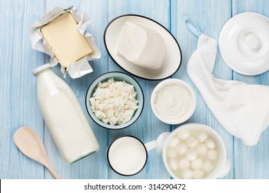 Dairy Products On Wooden Table. Sour Cream, Milk, Cheese, Egg, Yogurt And Butter. Top View