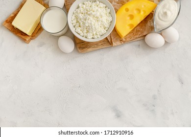 Dairy Products And Raw Eggs On White Background. Top View. Copy Space.