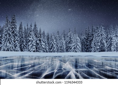 Dairy Star Trek above the winter woods. Cracks on the surface of the blue ice near hills of pines. Frozen lake in mountains. Carpathian Ukraine Europe. - Powered by Shutterstock