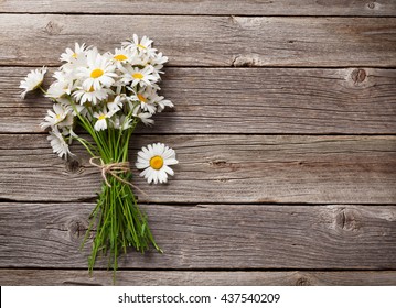 Daisy chamomile flowers on wooden background. View with copy space - Powered by Shutterstock