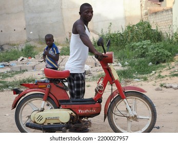 Dakar, Senegal, Africa, April 26 2021, A Man And His Moped In A Street In Dakar