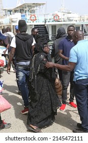 DAKAR, SENEGAL – MARCH 15, 2022: Woman In Traditional National Costume, Dress, Clothes In Dakar, Senegal, Africa. Senegalese Woman. Street Style, Afro Beauty. African Woman In Head Scarf, Headdress