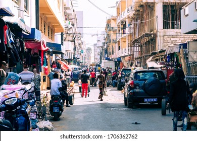 DAKAR, SENEGAL - NOVEMBER 11, 2019: People Working And Traffic At Senegal Capital Dakar, West Africa.