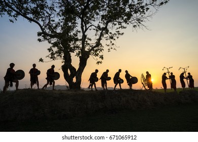 Daklak, Vietnam - Mar 9, 2017: Ede Ethnic Minority People Perform Gong And Drum Dance In Their Festival Under Big Tree In Sunset Period.