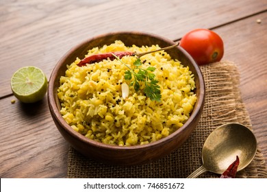 Dal khichadi or Khichdi Tasty Indian recipe served in bowl over moody background is made of toovar dal and rice combined with whole spices, onions, garlic and tomatoes etc. Selective focus
