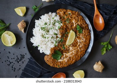 Dal makhani - Black lentil dhal mit Reis auf schwarzem Teller