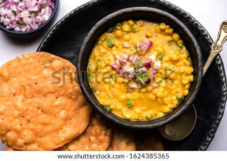Dal pakwan is an authentic Sindhi breakfast. It is a combination of deepfried, crisp and unpuffed Maida puris served with Daal made using chana or split chickpea. selective focus
