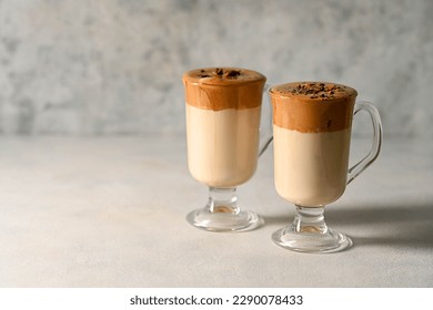 Dalgona coffee. Iced whipped coffee and milk. Refreshing coffee drink in glass cups, copy space